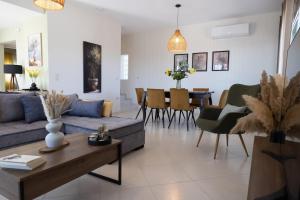 a living room with a couch and a table at House on the Hill in Anavyssos