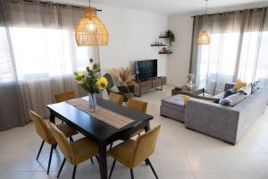 a living room with a table and a couch at House on the Hill in Anavyssos