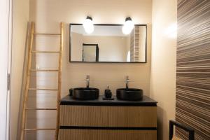 a bathroom with two sinks and a mirror at House on the Hill in Anavyssos +54 photos