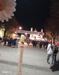 a pole in the middle of a street at night at Rise And Shine Rooms Korca in Korçë