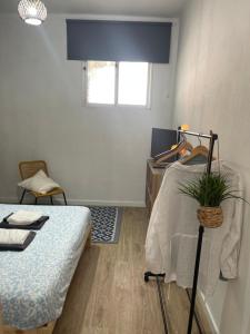 a bedroom with a bed and a table with a plant at Casa Alto da Vela in Peniche