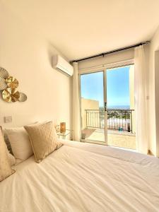 a bedroom with a bed and a large window at Tala Panorama View in Tala +23 photos