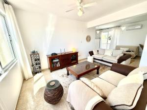a living room with a couch and a table at Tala Panorama View in Tala