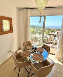 a living room with a table and chairs and a balcony at Tala Panorama View in Tala