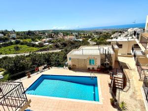 a large swimming pool in front of a house at Tala Panorama View in Tala