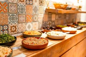a buffet with bowls of food on a counter at Hotel Hallormsstadur in Egilsstaðir +138 photos