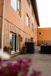 a building with potted flowers in front of it at Hotel Hallormsstadur in Egilsstaðir