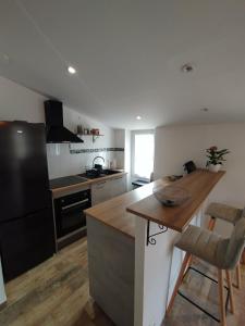 a kitchen with a black refrigerator and a counter at Appartement dans la campagne in Le Beausset