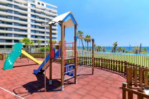 a playground at the beach with a slide at Apartment Grape Panorama Mar Punta Prima in Punta Prima