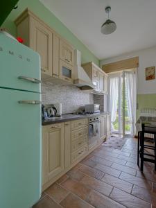 a kitchen with wooden cabinets and a white refrigerator at IL TORRINO in Golasecca