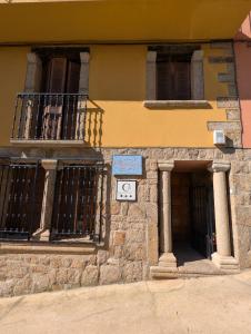 a building with a clock on the side of it at Casa Rural Maire TR-CC-00590 in Gata +11 photos