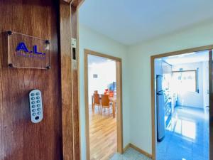a door with a remote control next to a dining room at Maria Borges Alojamento Local in Póvoa de Varzim