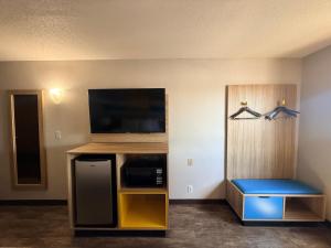 a hotel room with a flat screen tv and a room at Days Inn by Wyndham Orange Park/Jacksonville in Orange Park