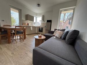 a living room with a couch and a table at KutyaGazdi Apartman in Balatonfenyves