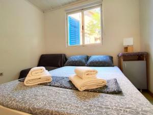 a bedroom with a bed with towels on it at Apartments Skipper bay Kumbor in Herceg-Novi