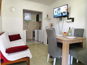 a living room with a dining room table and a kitchen at Apartments Skipper bay Kumbor in Herceg-Novi