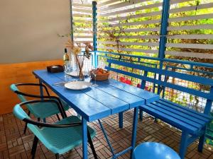 a blue table and chairs in a room with a window at Apartments Skipper bay Kumbor in Herceg-Novi