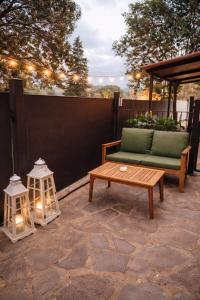 a patio with a couch and a table and lights at ClaMar Apart Hotel in Porto Ercole