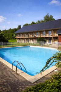 a large swimming pool in front of a hotel at Studio les Hauts de Honfleur in Équemauville