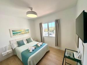 a bedroom with a bed with two towels on it at Santa Brígida in Cala en Porter