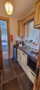 a kitchen with a sink and a counter top at Three Hares Farmhouse, Galway in Craughwell