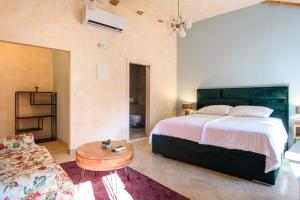 a bedroom with a bed and a table and a couch at Bottega in Mlini