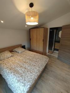 a bedroom with a large bed and a light at Appartement dans la campagne in Le Beausset