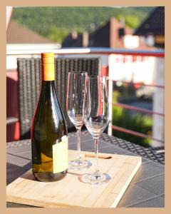 a bottle of wine and two wine glasses on a table at Schwarzwaldpension Tuttlingen in Tuttlingen