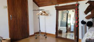 a room with a floor lamp and a mirror at Le Grenier d'Artiste in Laguépie