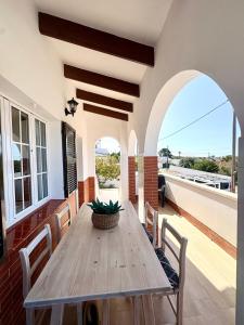 a dining room with a wooden table and chairs at Santa Brígida in Cala en Porter