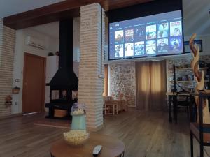 a living room with a tv and a fireplace at La Cambra casa rural Premium in Potríes