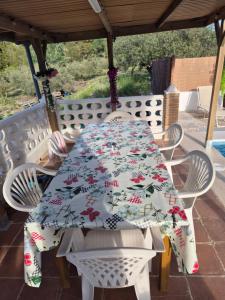 a table and chairs under a gazebo at beautiful guest room with swimming pool in Gormach