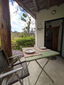 a table and a chair on a patio at TerraFazBem in Marvão +77 photos