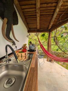 a kitchen with a sink and an elephant on the wall at TerraFazBem in Marvão