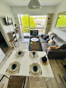 a living room with a couch and a table at La case du trimaran in Cabourg