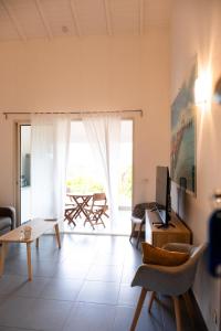 a living room with a couch and a table with a television at Quiet loft studio - Pinel side in Cul de Sac