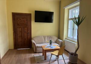 a living room with a couch and a table at Zeilinger Villa in Knittelfeld