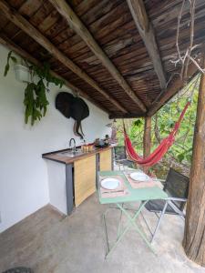 a kitchen with a table and a table and chairs at TerraFazBem in Marvão