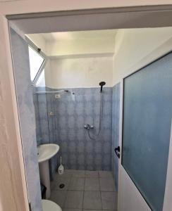 a bathroom with a shower and a toilet and a sink at Renato Rooms & Apartments in Vlorë