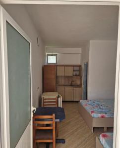 a bedroom with a bed and a table and chairs at Renato Rooms & Apartments in Vlorë