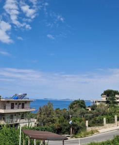 a view of the ocean from a house at Renato Rooms & Apartments in Vlorë