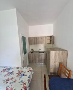 a kitchen with a bed and a sink in a room at Renato Rooms & Apartments in Vlorë +18 photos