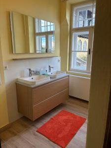 a bathroom with two sinks and a window at Zeilinger Villa in Knittelfeld +29 photos