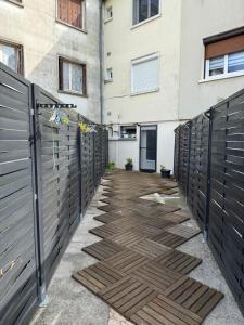 a walkway with a fence and a building at Le studio de Louisette in Châteaudun