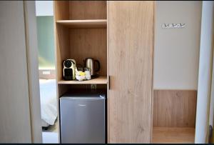 a cupboard with a refrigerator in a room at Okeanis Hotel Tyros in Tyros