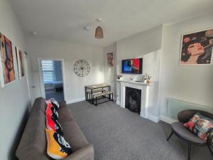 a living room with a couch and a fireplace at Castle View Dover in Dover