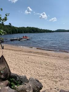 a beach with a dock and a boat in the water at The Boardwalk in Westfield Beach