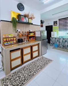 a kitchen with a counter and a refrigerator at Homestay DAR AL - JUFRY fully aircond in Kuantan