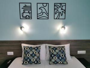 a bedroom with a bed with four pictures on the wall at Villa Olympia in Paralia Katerinis