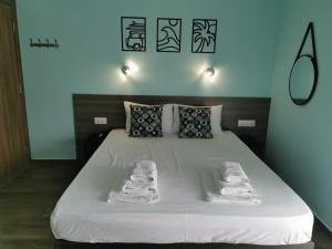 a bedroom with a bed with towels on it at Villa Olympia in Paralia Katerinis